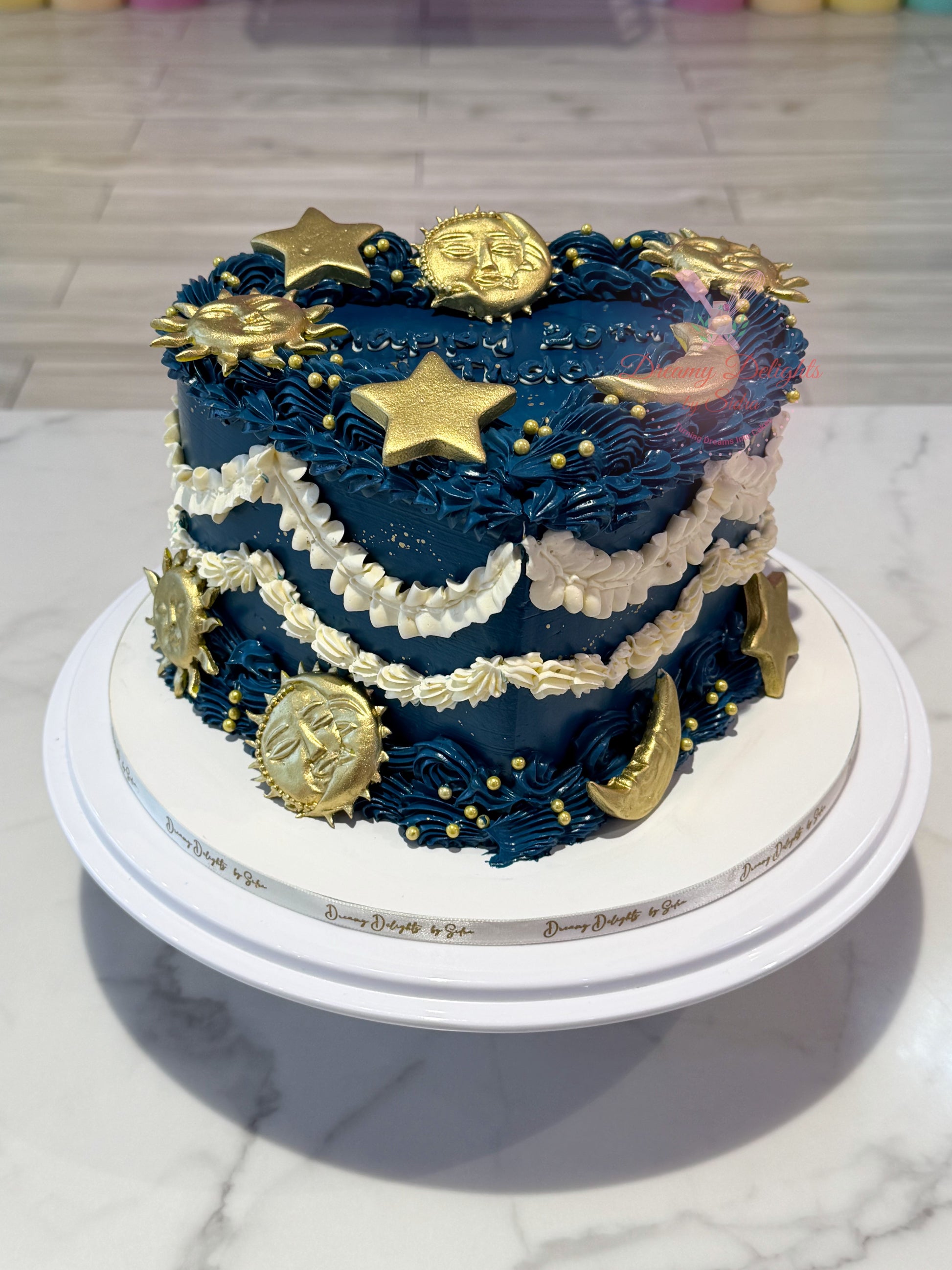 Moon and stars vintage heart cake with navy blue buttercream, gold celestial decorations, and elegant vintage piping for birthdays in Dubai.