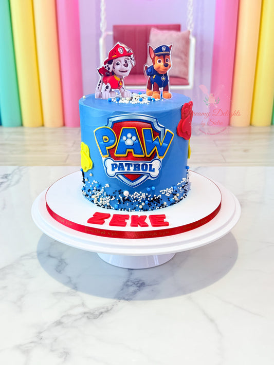 Paw Patrol birthday cake with cartoon characters on a marble surface