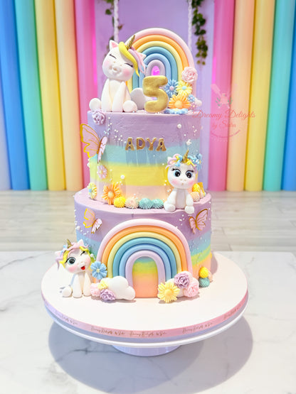 Personalized unicorn rainbow birthday cake with pastel colors, handcrafted unicorn toppers, flowers, butterflies, and rainbow decorations for girls in Dubai.