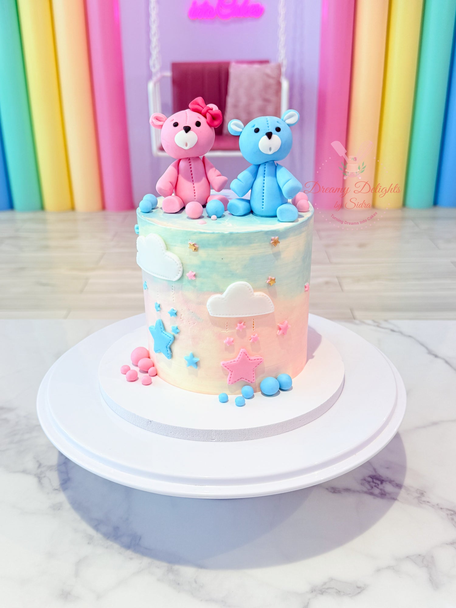 Colorful cake with teddy bears on a marble surface and colorful background