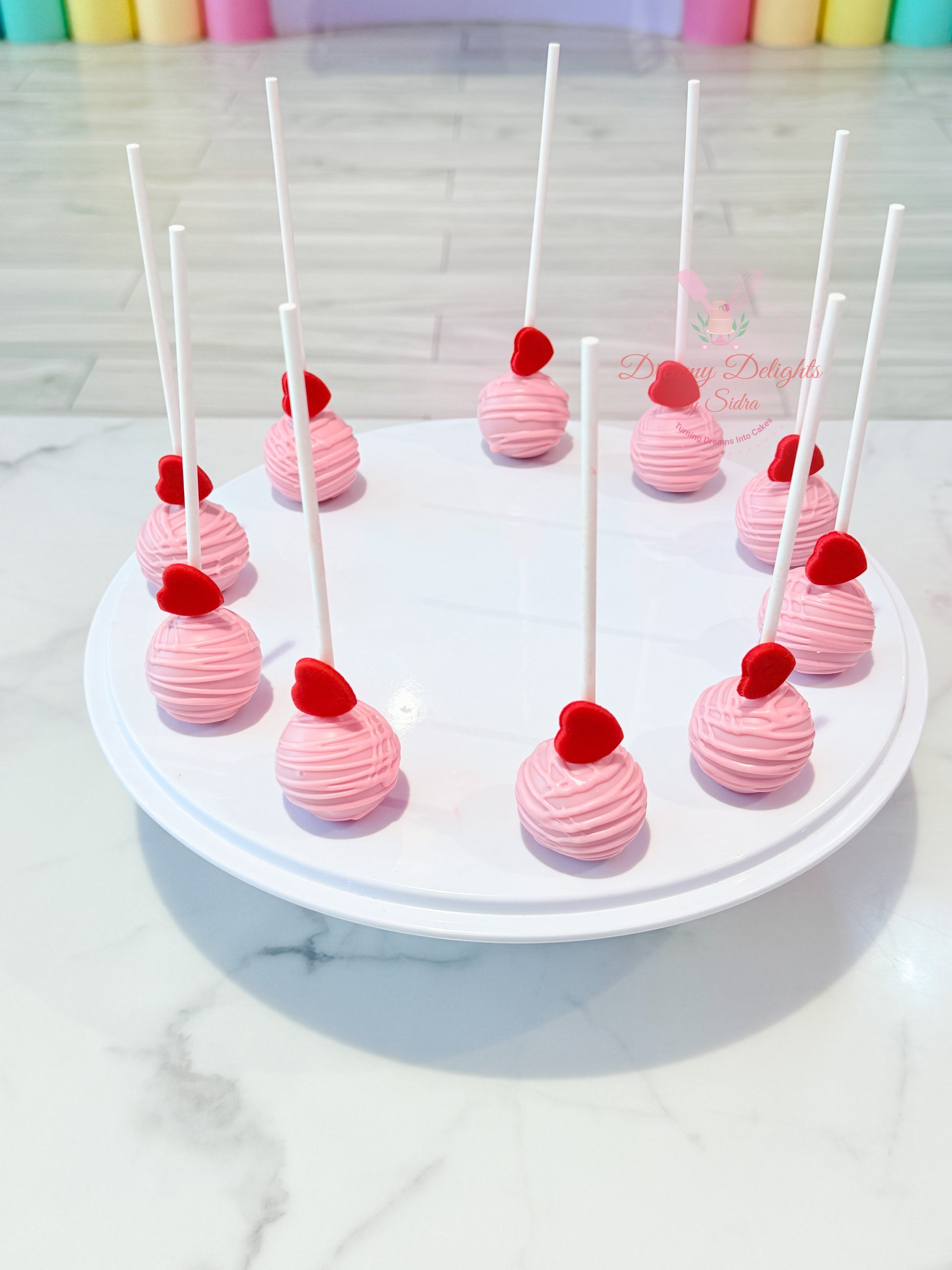Pink heart cake pops with edible heart toppers for birthdays, baby showers, Valentine's Day and celebrations in Dubai.