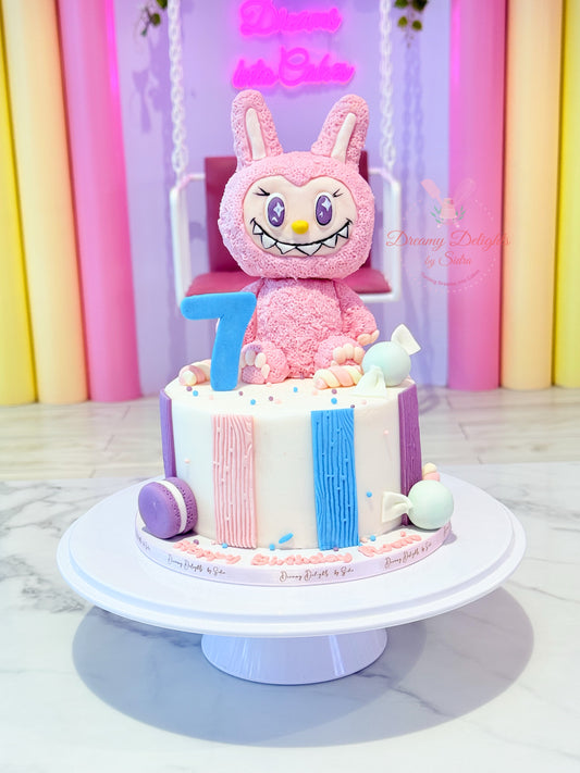 Birthday cake with a pink cartoon character on a white stand against a colorful background