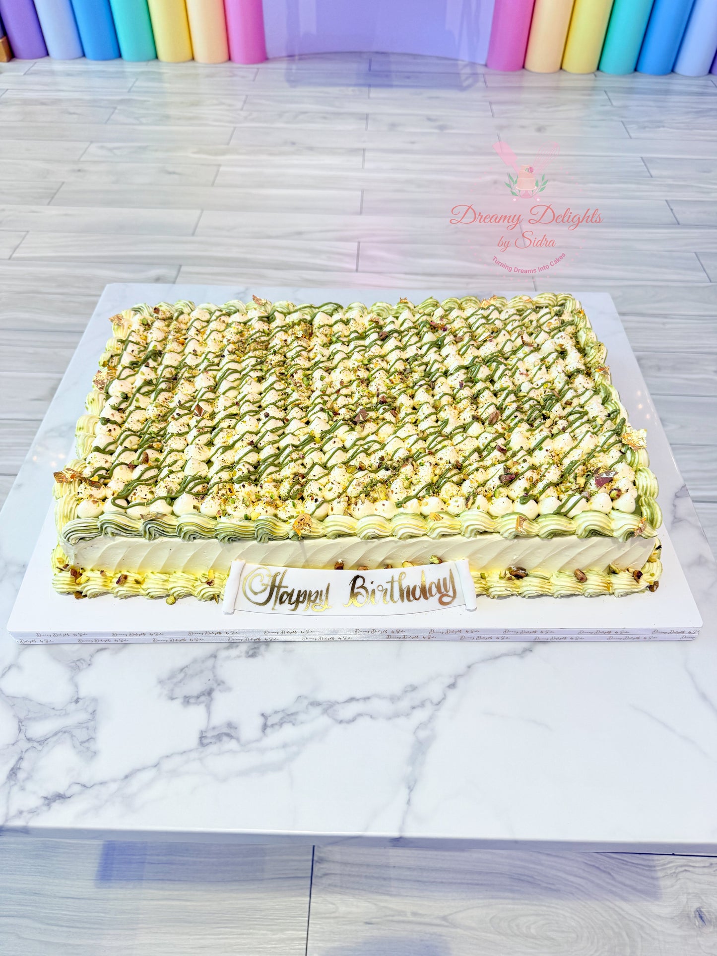 Pistachio sheet cake with buttercream frosting and nut garnish