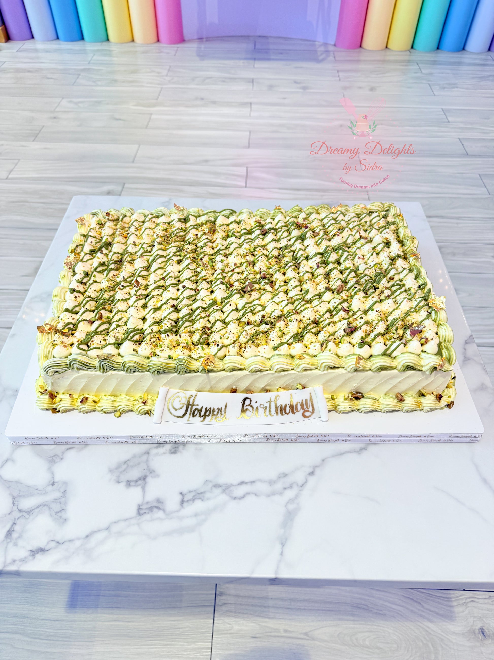 Pistachio sheet cake with buttercream frosting and nut garnish