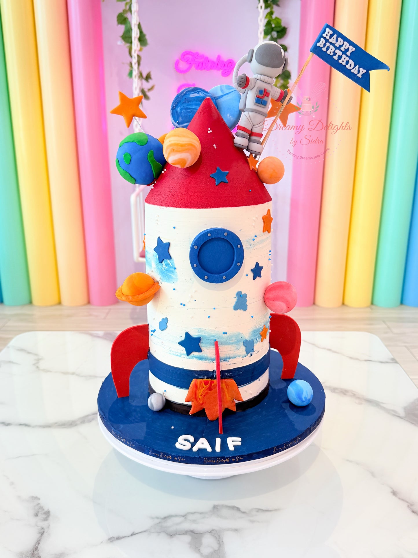 Space rocket ship and astronaut cake with planet theme for boys birthday celebration in Dubai