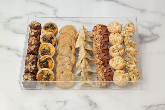 Ramadan acrylic tray with brownies mini quiche chocolate chip cookies fatayer chicken puffs and sable cookies Ramadan snack platter Dubai