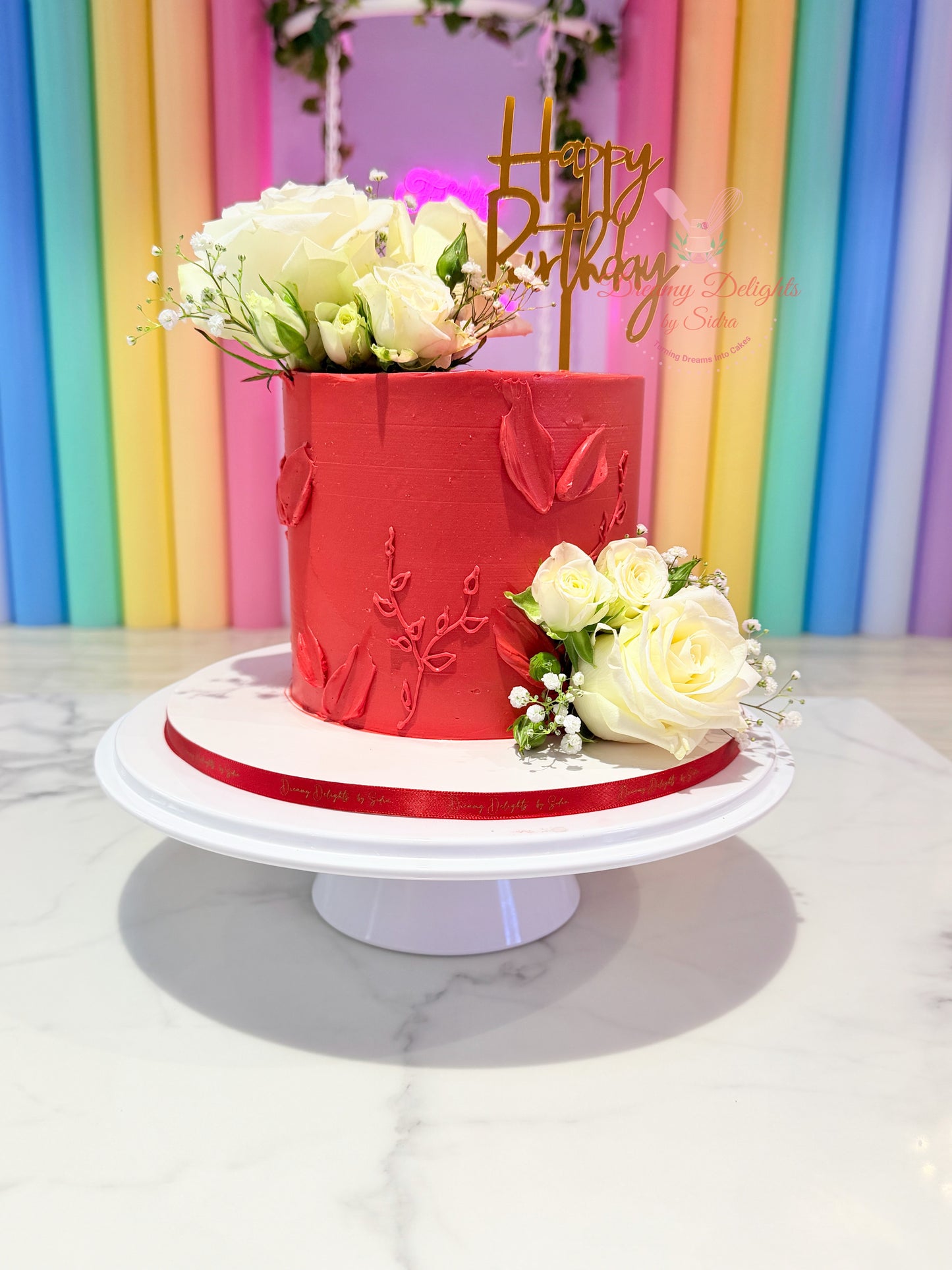 Red and white floral wedding anniversary cake with romantic design in Dubai