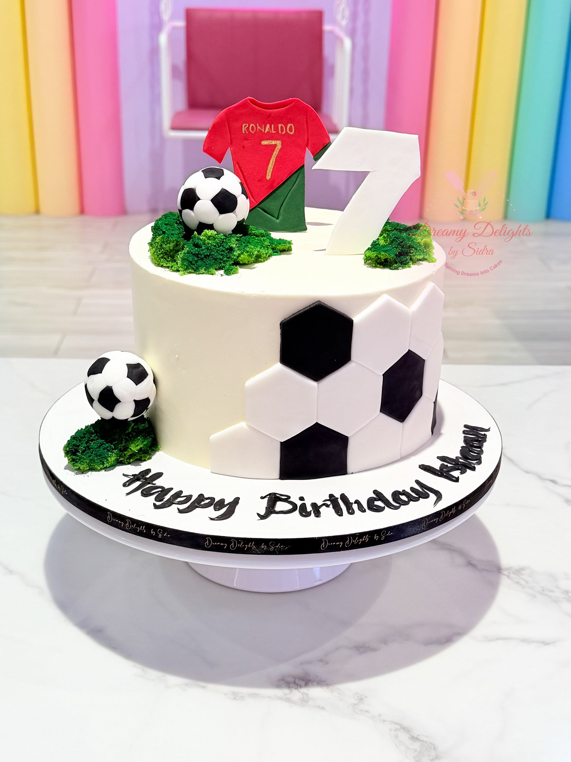 Football Ronaldo jersey birthday cake with soccer ball decorations and football field theme for boys in Dubai