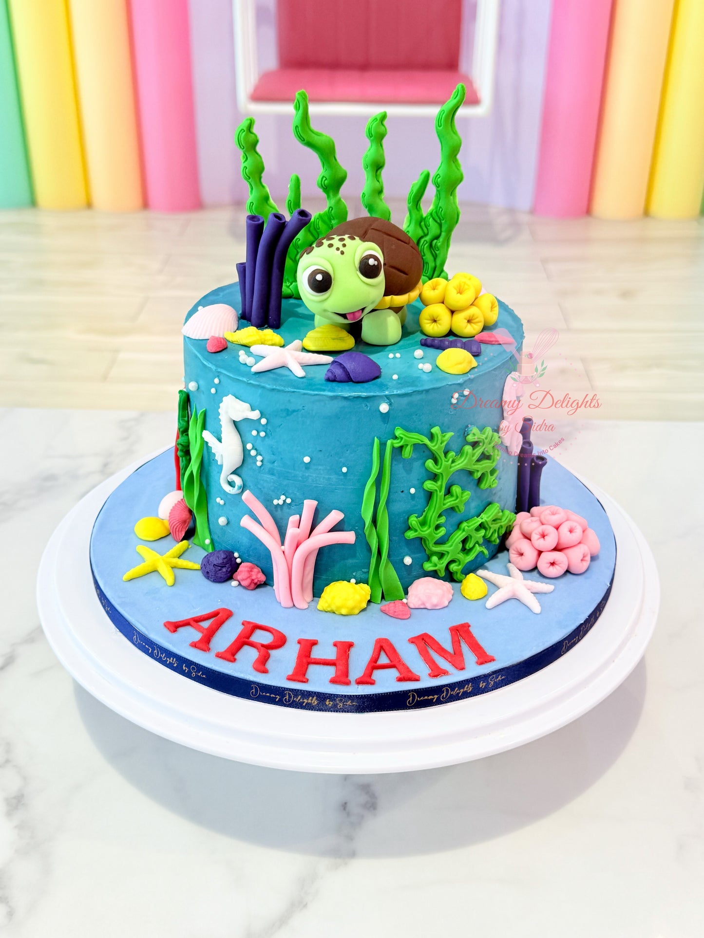 Sea Turtle themed kids birthday cake for boys with cute turtle topper and underwater coral decorations in Dubai