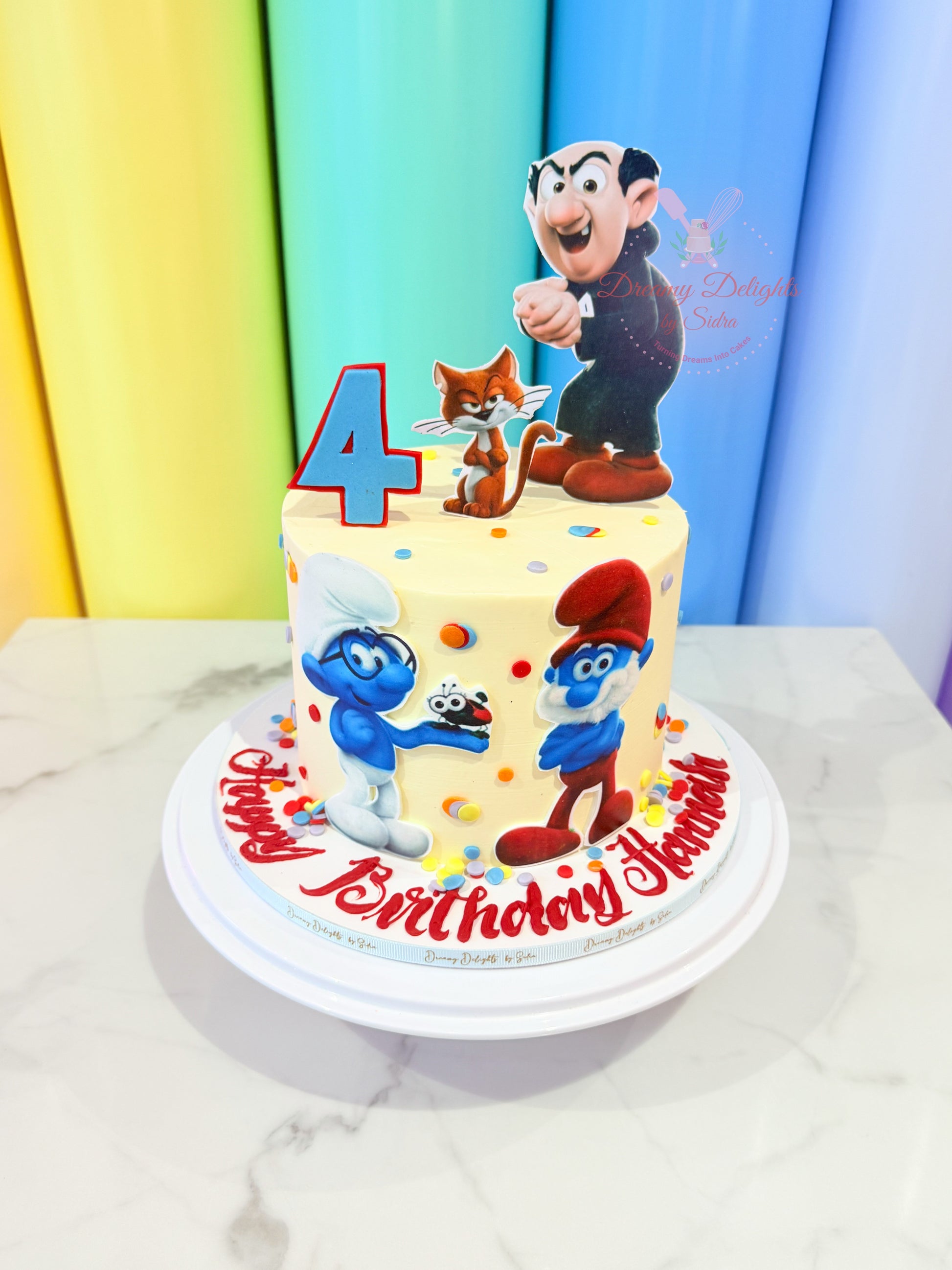 Smurfs birthday cake with cartoon characters and age topper for kids party in Dubai