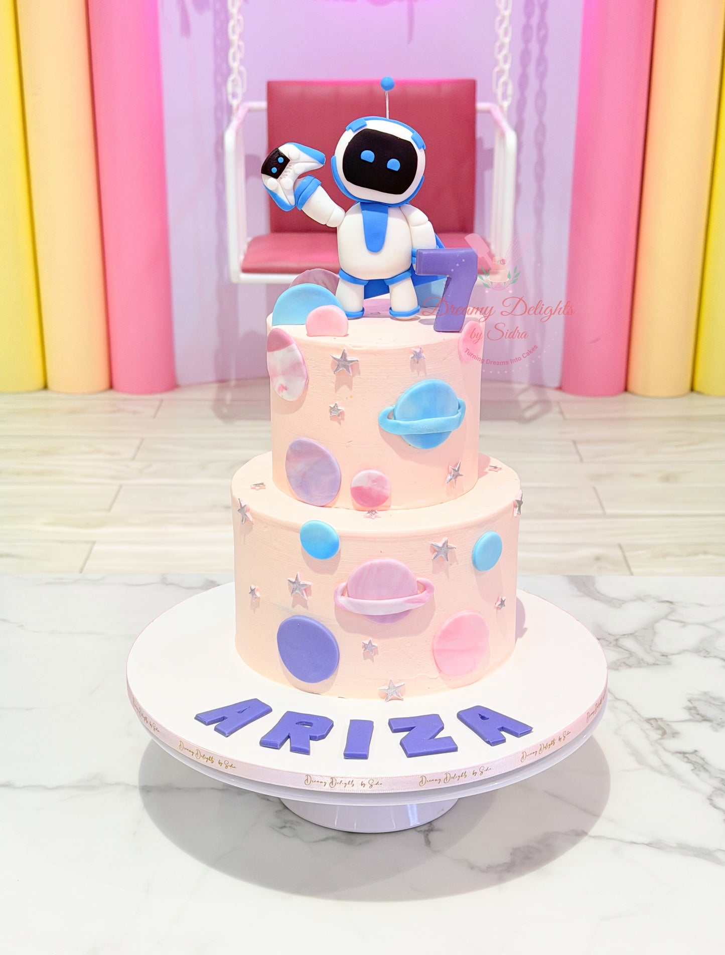 Space Theme Birthday Cake Dubai featuring Astrobot astronaut design, planets decoration, and customized kids birthday cake for girls.
