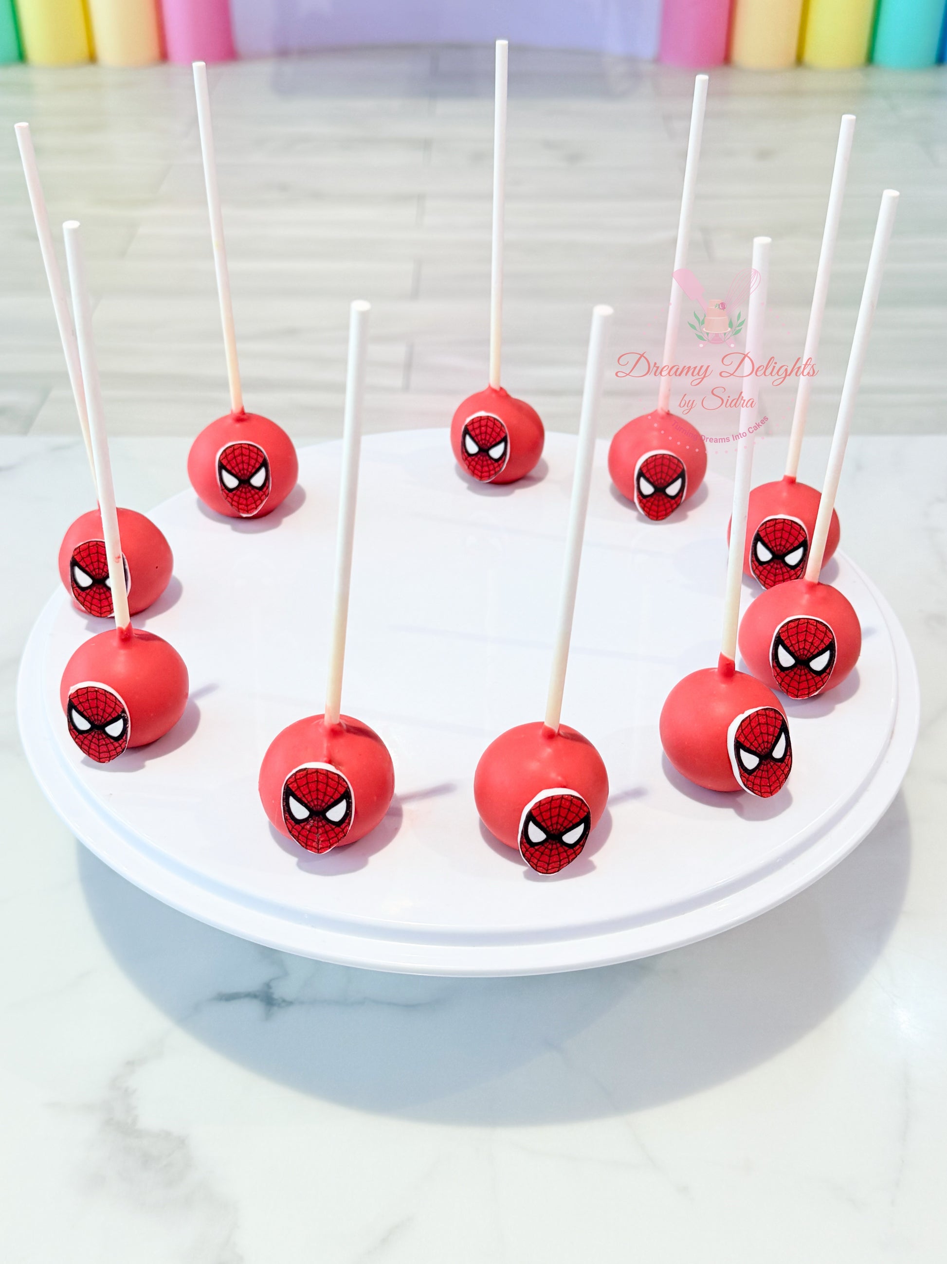 Spider-Man themed cake pops with edible superhero toppers for kids birthday parties and celebrations in Dubai.