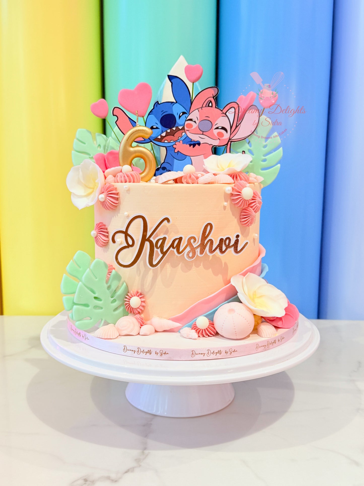 Stitch and Angel themed birthday cake with tropical decorations for girls birthday party in Dubai