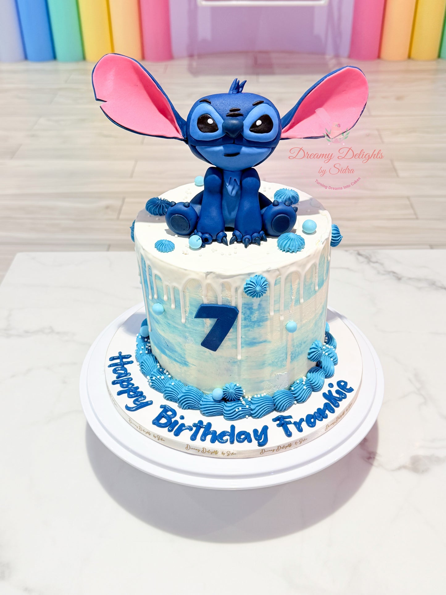 Stitch birthday cake with 3D fondant topper and blue drip design for girls kids celebration