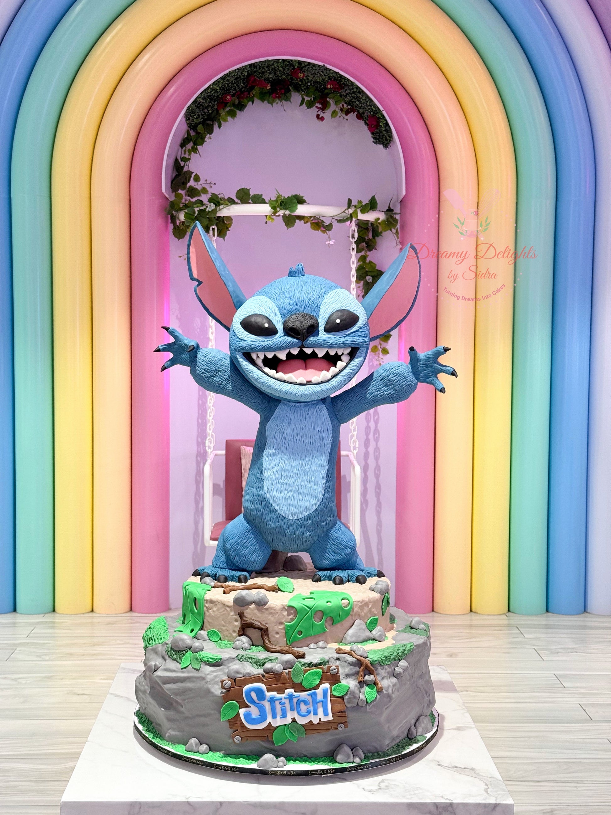 Stitch cake in front of a colorful archway