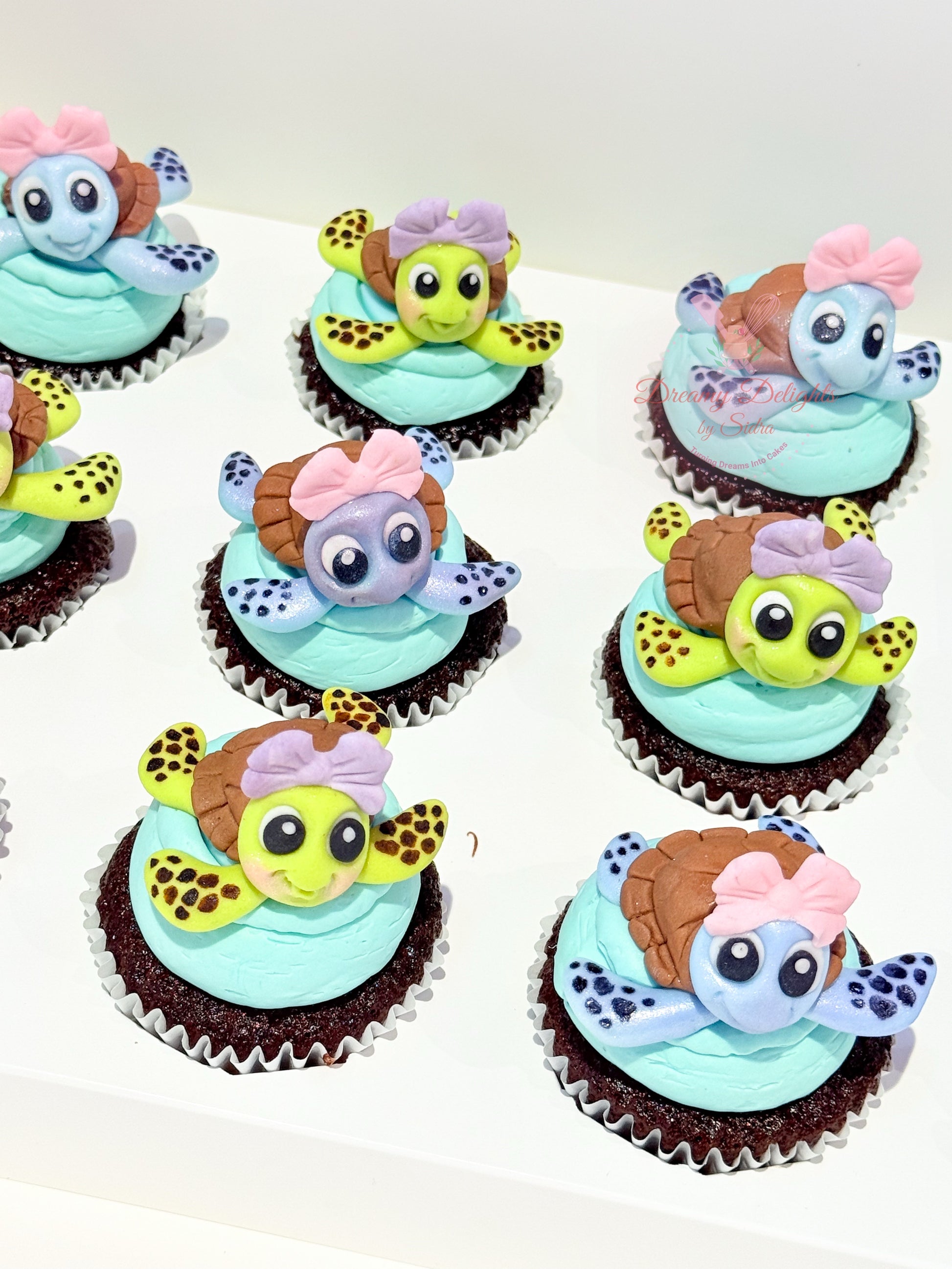 Cupcakes decorated with turtle-themed frosting on a white background