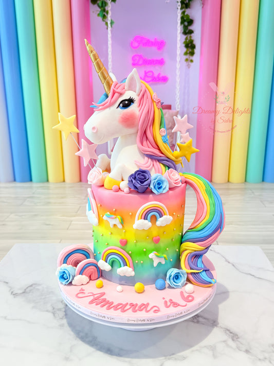 Colorful unicorn cake with rainbow decorations on a marble surface against a colorful curtain background.