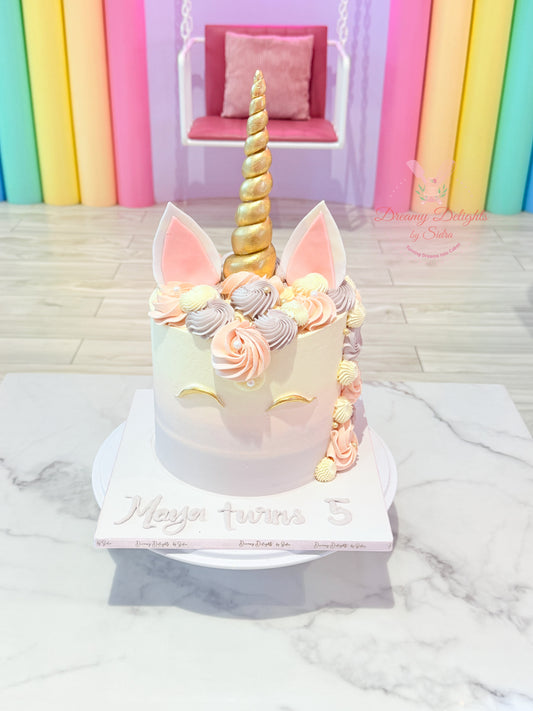 Unicorn-themed birthday cake with colorful decorations on a marble surface.