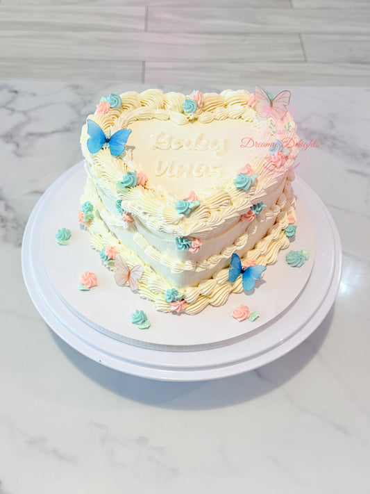 Vintage heart baby shower cake with pastel pink and blue butterflies