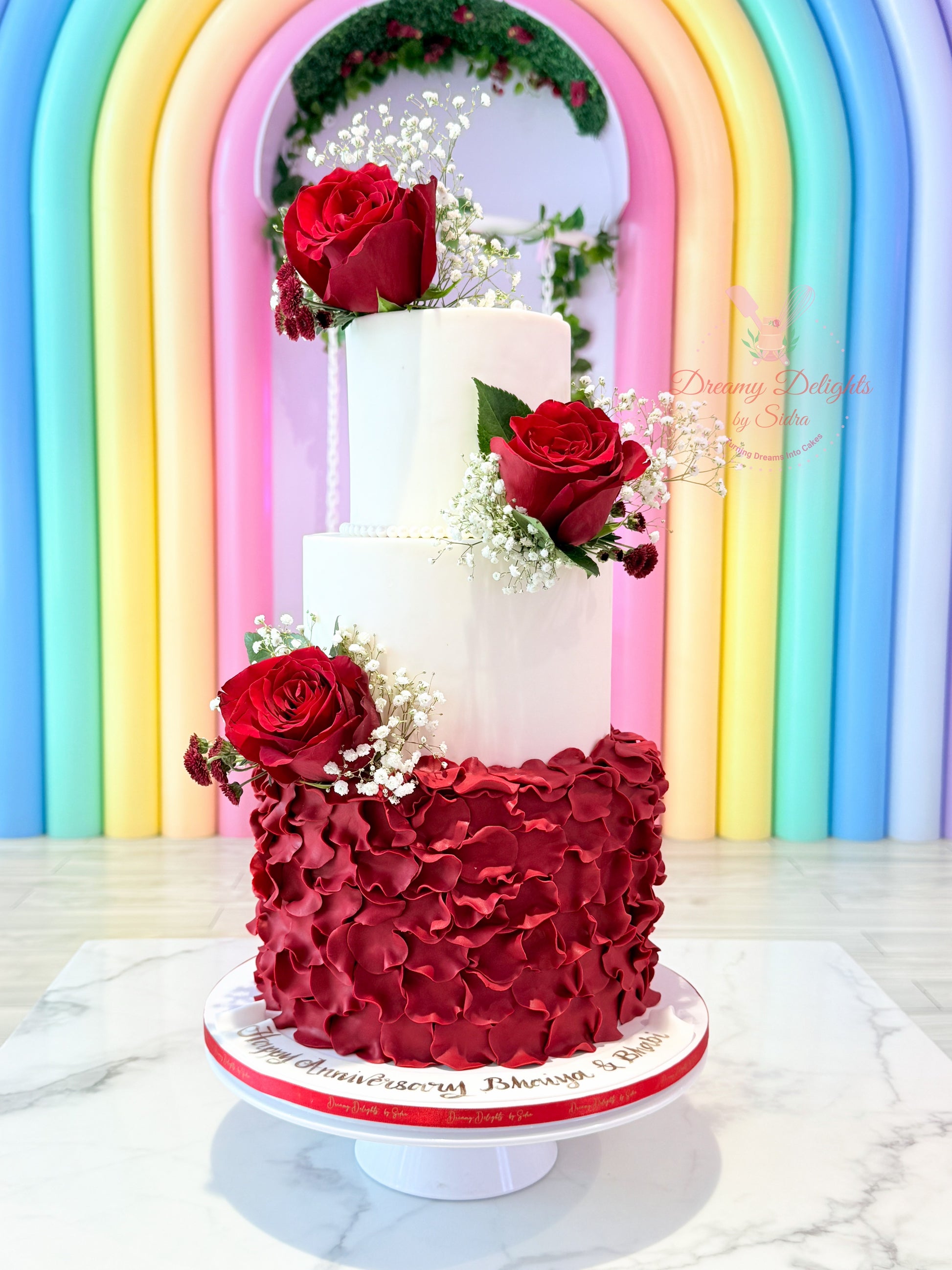 Three-tiered cake with red floral wedding anniversary cake