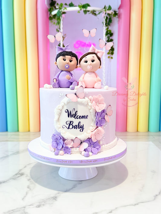 Welcome twins baby shower cake with boy and girl baby toppers in pastel theme Dubai