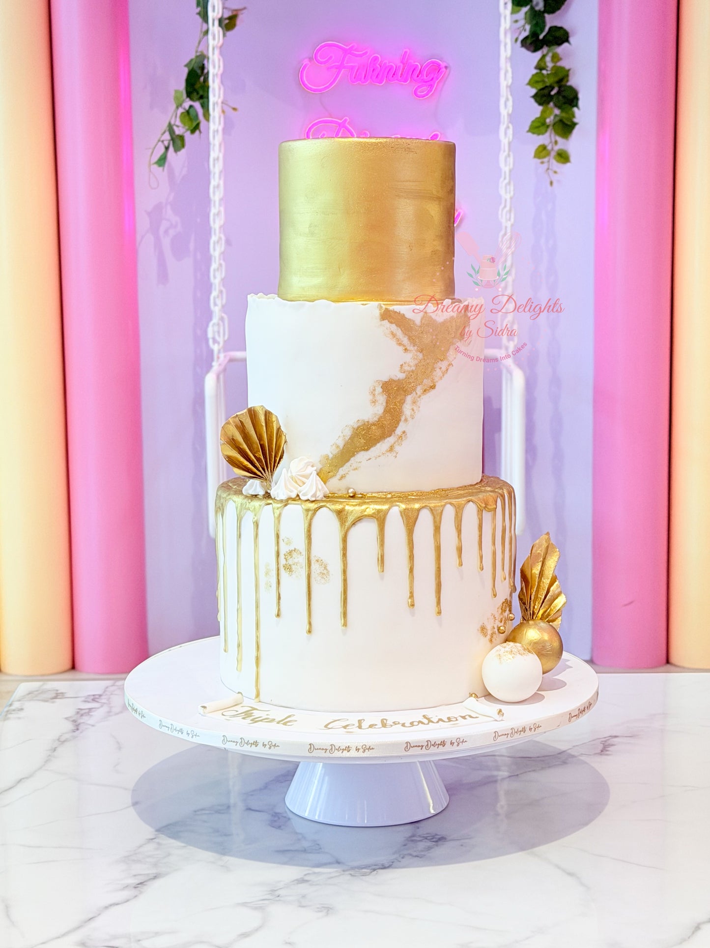 White and gold three-tier anniversary cake handcrafted by Dreamy Delights by Sidra for elegant celebrations in Dubai.