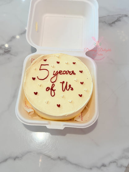 Years of Us bento cake with ivory frosting, red hearts and romantic message by Dreamy Delights by Sidra in Dubai.